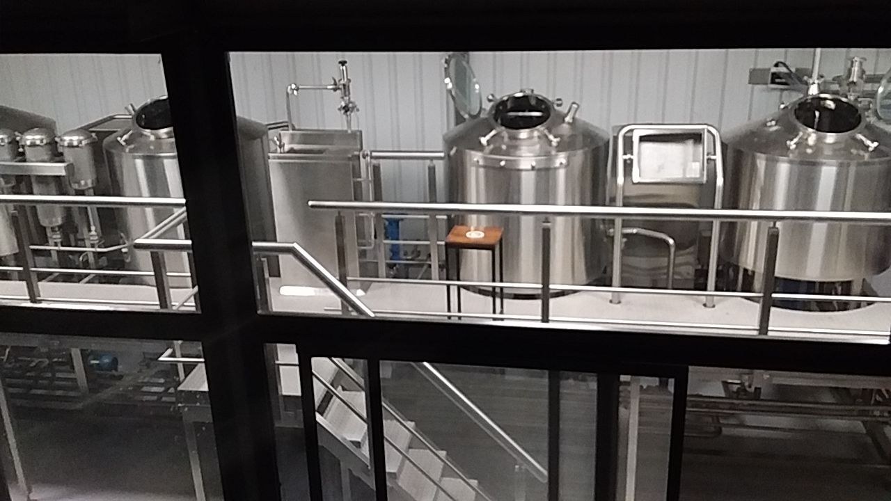 Bloque de cocción de 500 litros instalado — tanques y plataforma en acero inoxidable